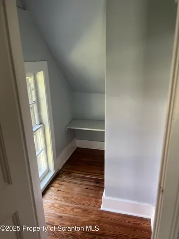 a bathroom with a mirror and a shower