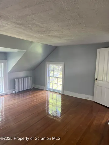 a white toilet sitting next to a white wall