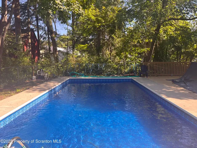 a view of a yard with wooden fence