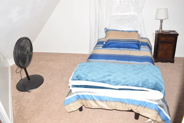 a bedroom with a bed and lamps