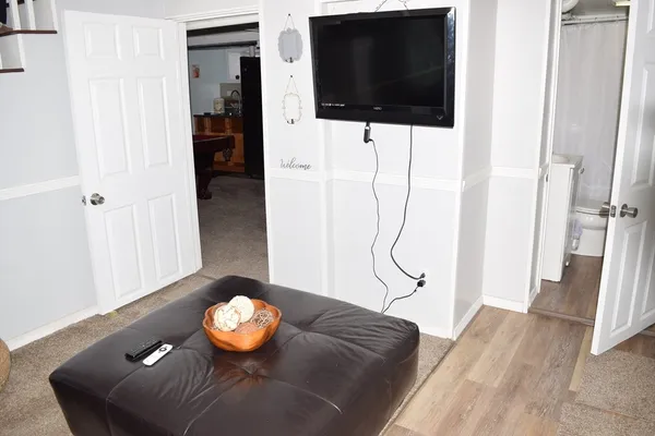 a room with pool table flat screen tv and outdoor view