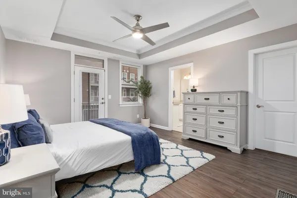 a spacious bedroom with a large bed a chandelier and closet