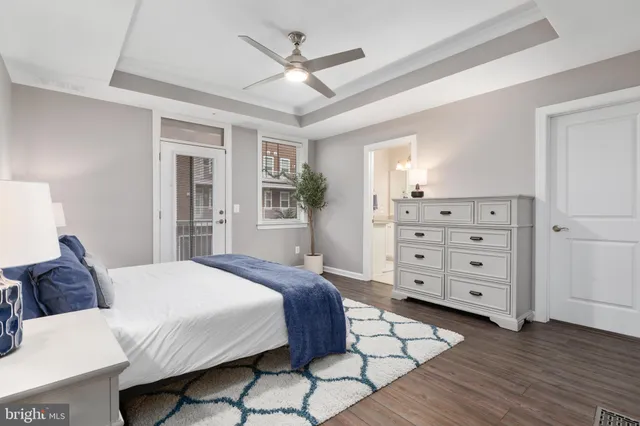 a spacious bedroom with a large bed a chandelier and closet