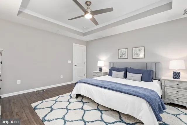 a bedroom with a bed and a ceiling fan