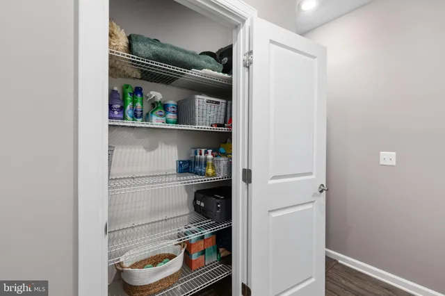 a kitchen with a refrigerator and a wooden floor