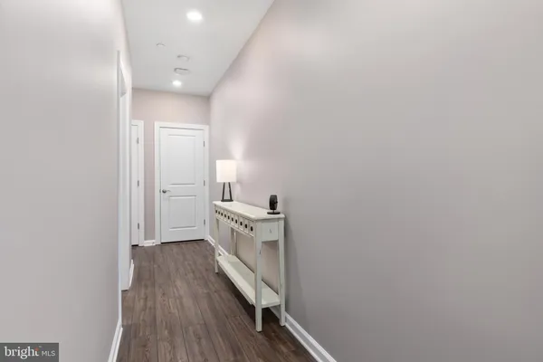 a view of a hallway with wooden floor