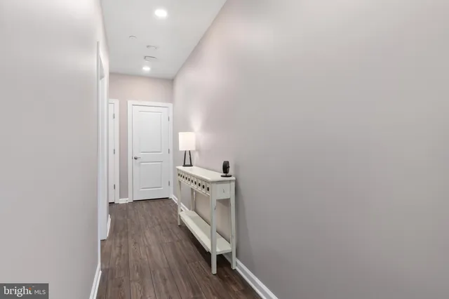 a view of a hallway with wooden floor