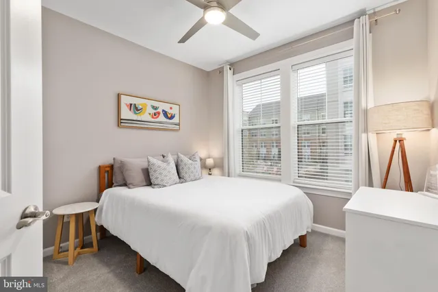 a bedroom with bed and a large window