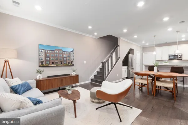 a dining room with furniture and wooden floor