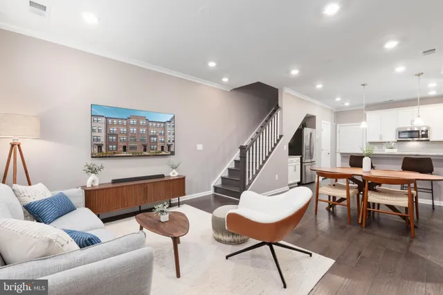 a dining room with furniture and wooden floor