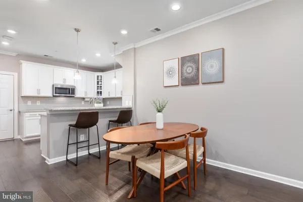 a kitchen with a table and chairs in it