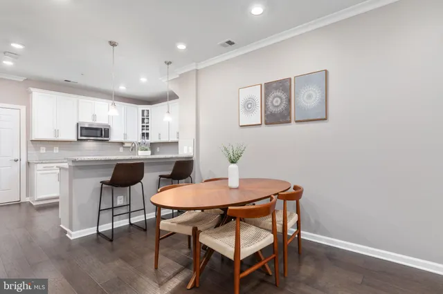 a kitchen with a table and chairs in it