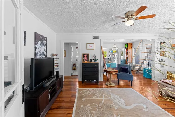 a living room with furniture and wooden floor