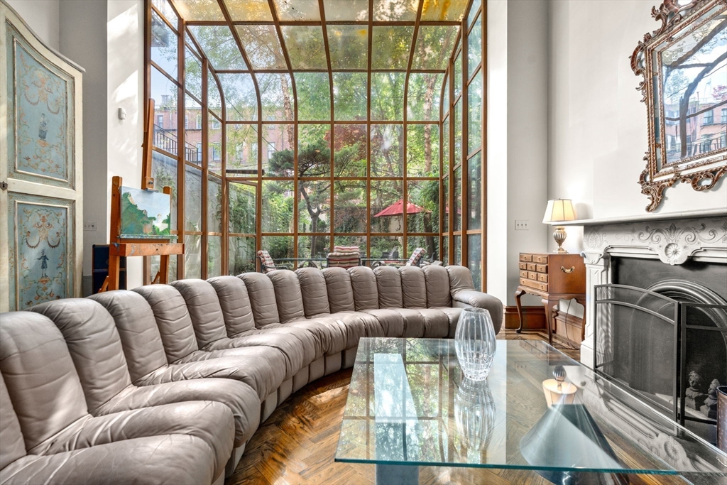 168 West Canton Street Boston, MA 02118 - Photo 5 of 10 a living room with furniture large windows and a fireplace
