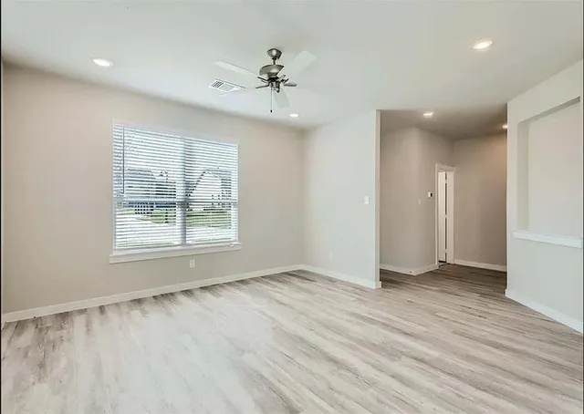 a kitchen with granite countertop a stove top oven sink and cabinets