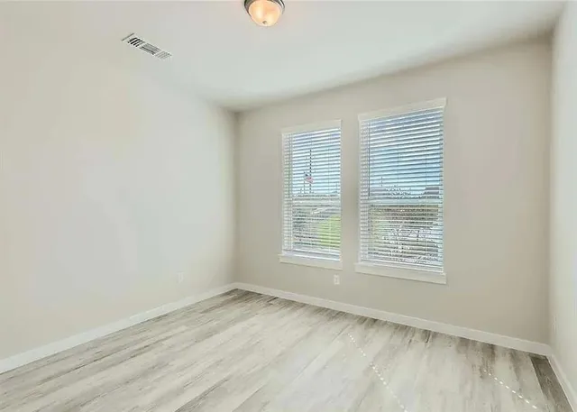 a view of an empty room with a window