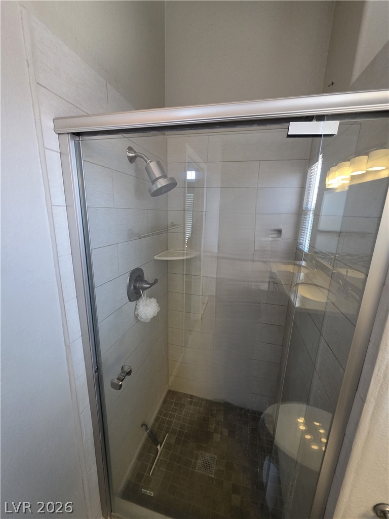 2275 Ramsgate Drive Henderson, NV 89074 - Photo 64 of 84 A well-appointed shower features modern tiling and a sleek glass enclosure.