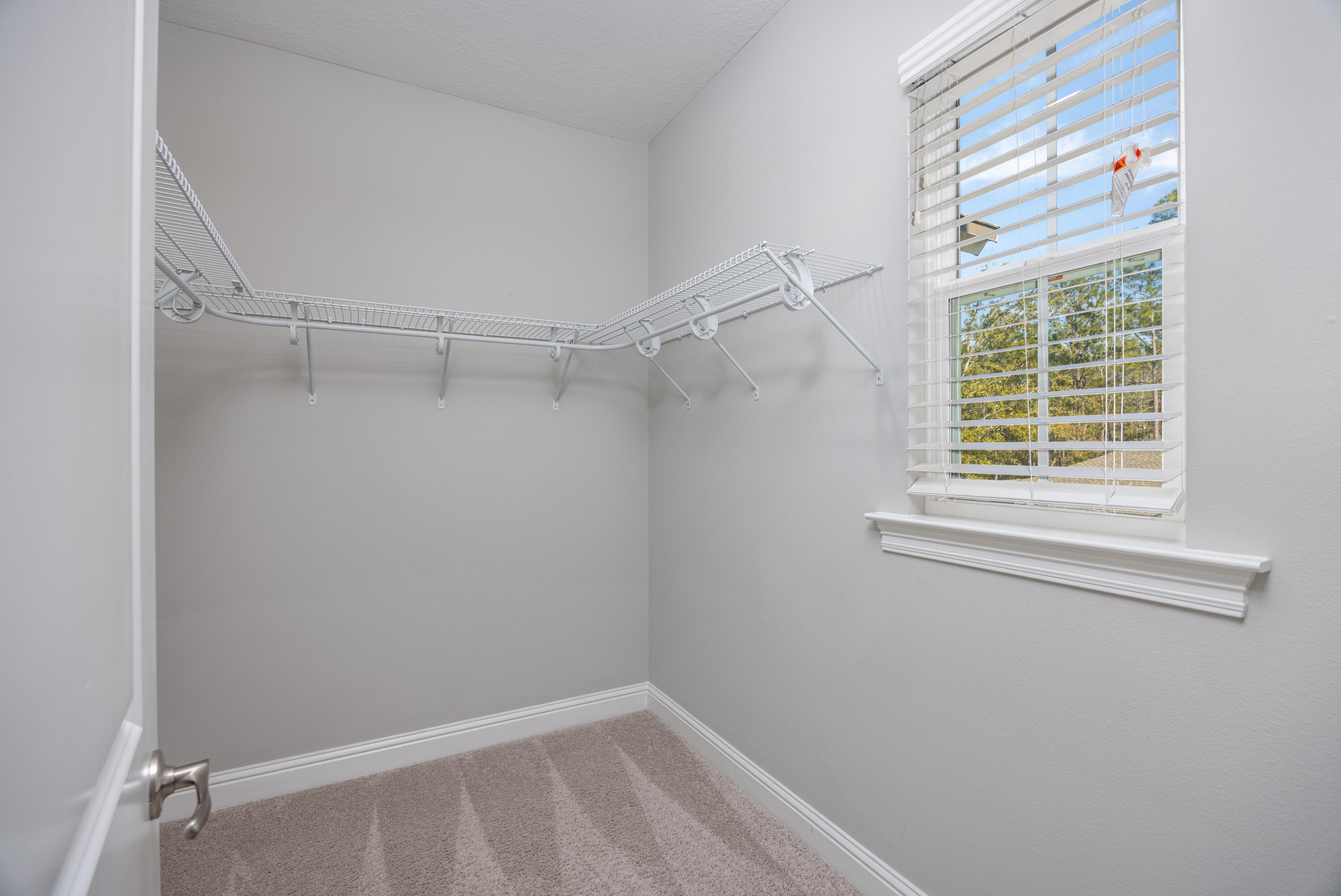 134 Laurel Oaks Drive Freeport, FL 32439 - Photo 24 of 30 a view of a room with rack on the wall and a window