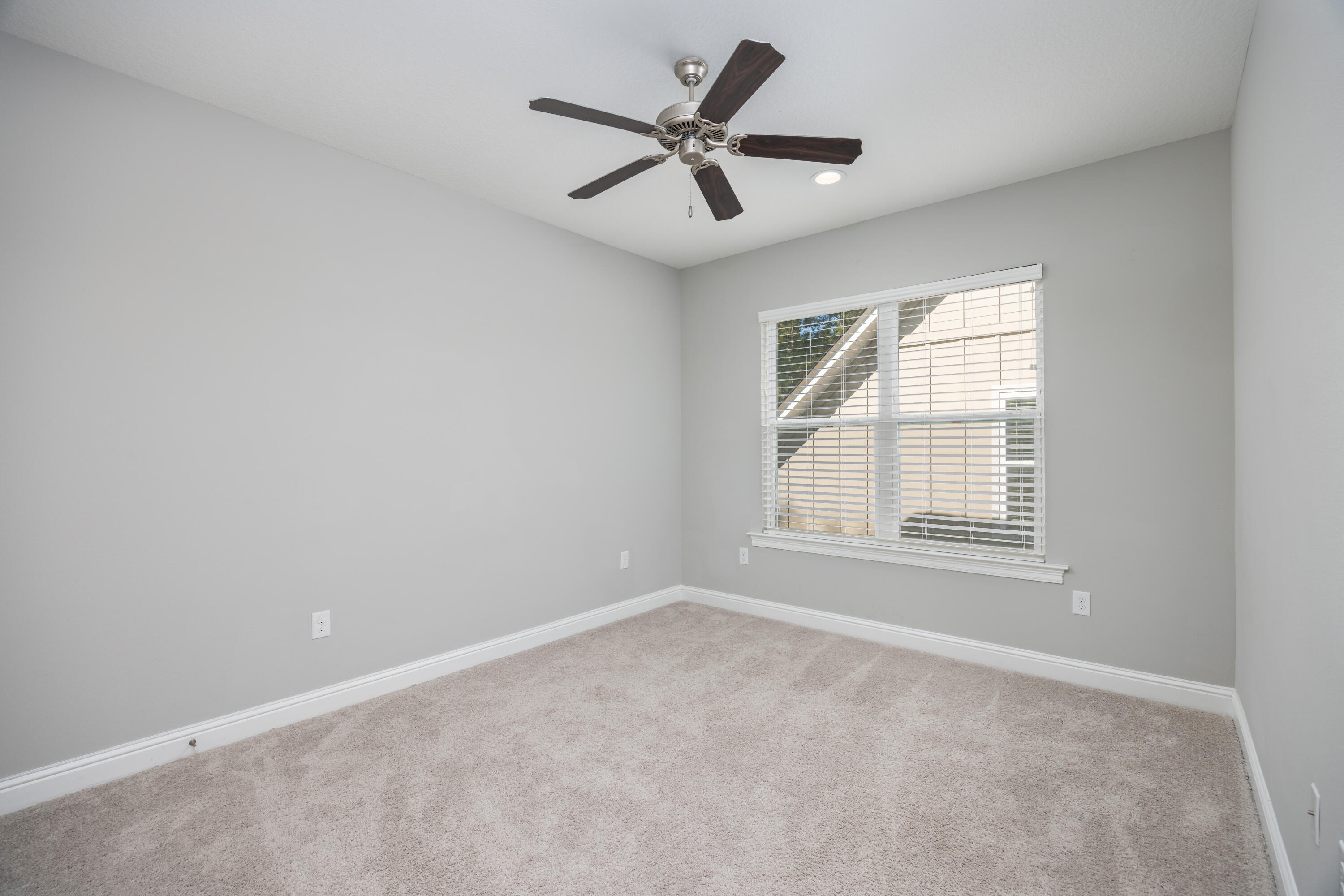 134 Laurel Oaks Drive Freeport, FL 32439 - Photo 25 of 30 an empty room with ceiling fan and windows