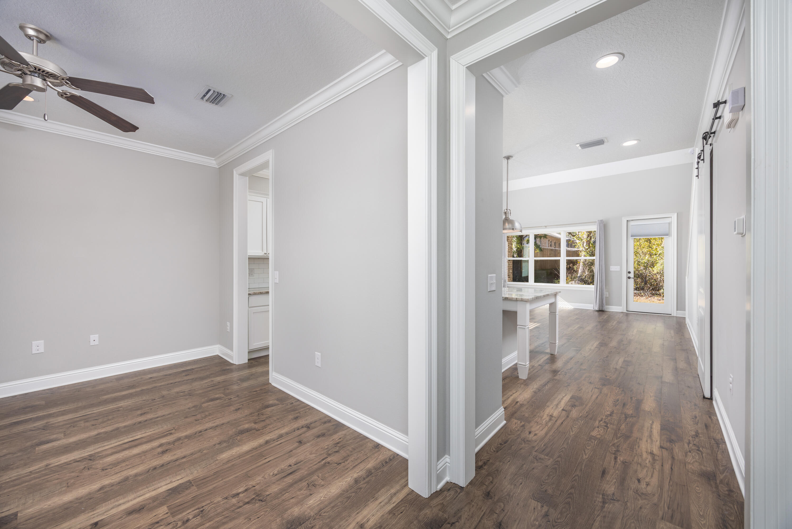 134 Laurel Oaks Drive Freeport, FL 32439 - Photo 3 of 30 a view of a hallway with wooden floor and windows