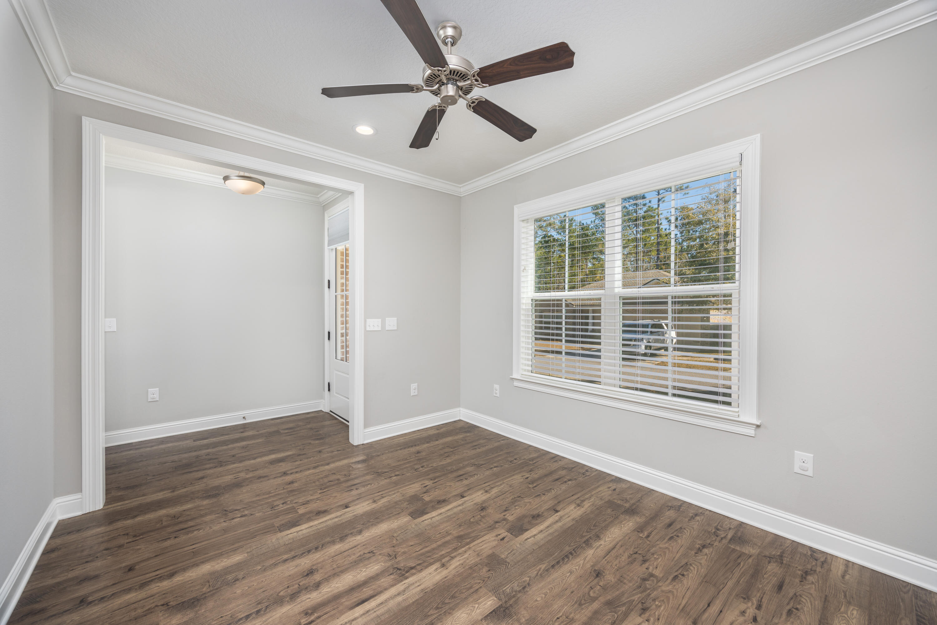 134 Laurel Oaks Drive Freeport, FL 32439 - Photo 5 of 30 a view of an empty room with a window and wooden floor