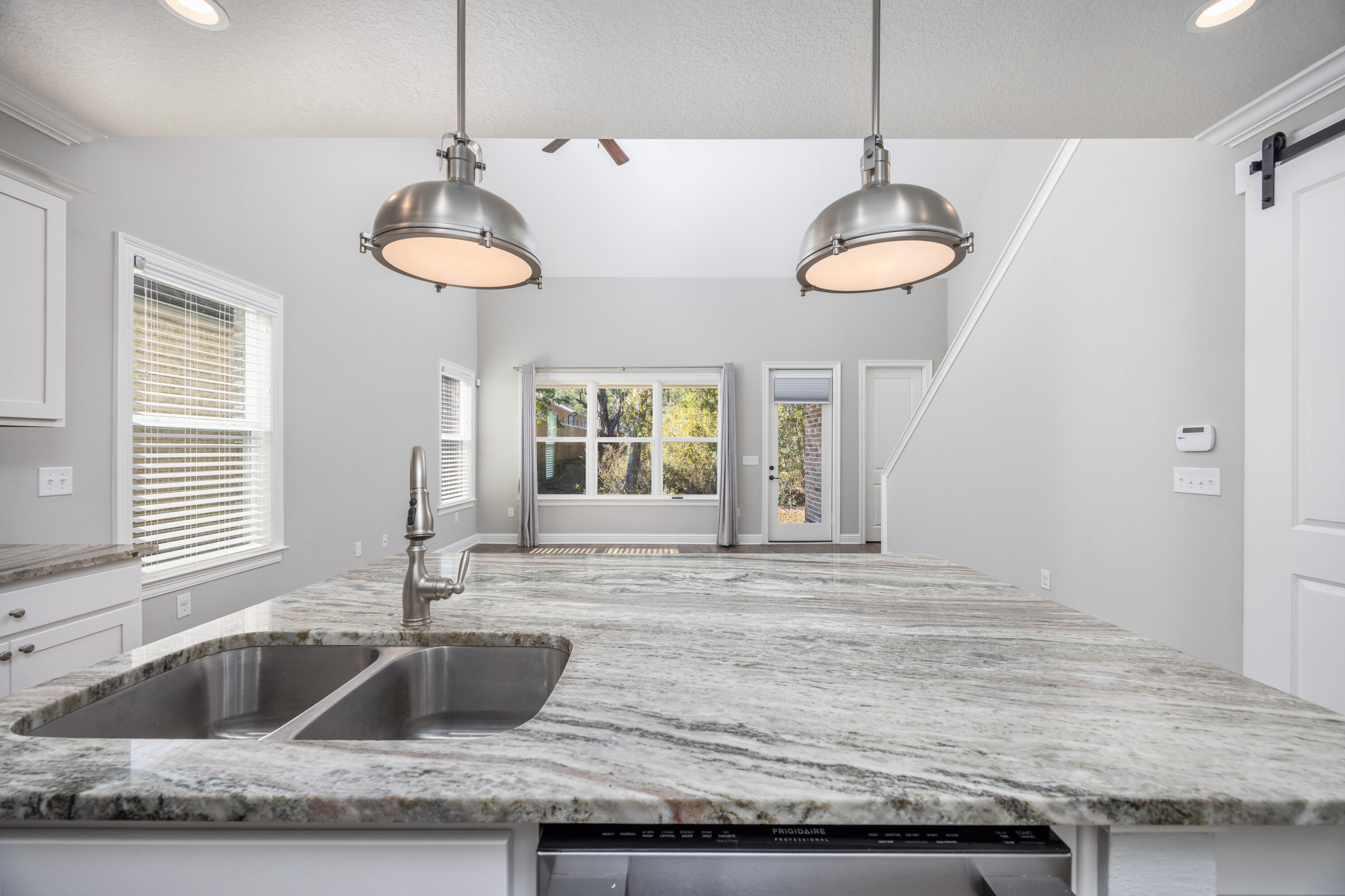 134 Laurel Oaks Drive Freeport, FL 32439 - Photo 10 of 30 a kitchen with granite countertop counter space a sink and a window