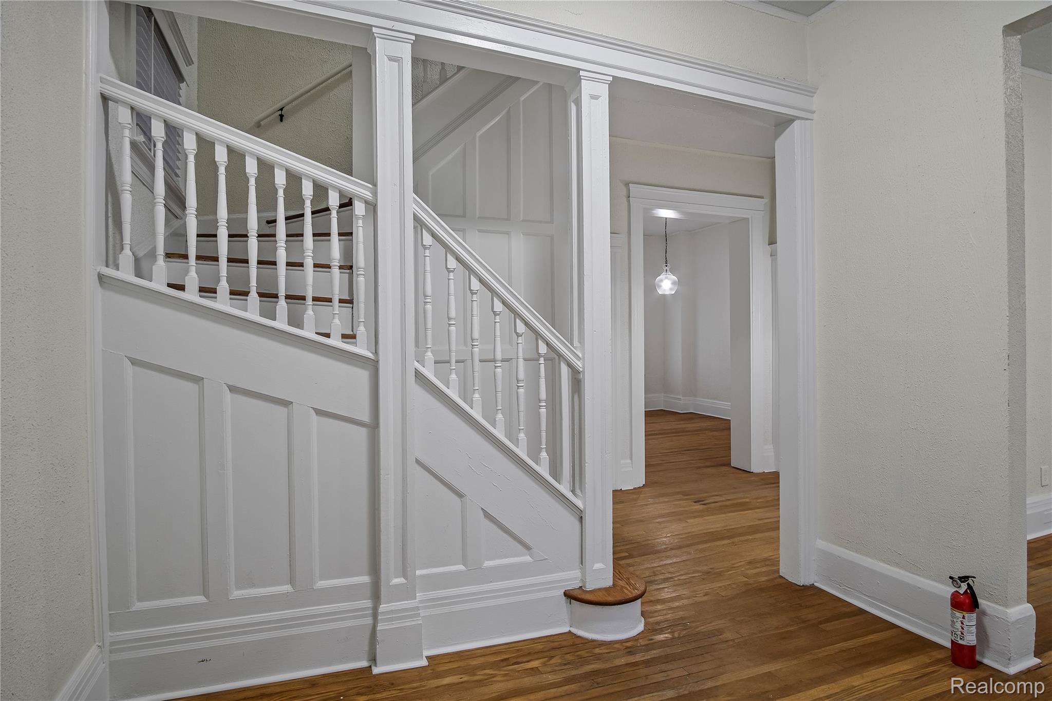 427 Melbourne Street Detroit, MI 48202 - Photo 2 of 29 Stairway with wood-type flooring and a textured wall