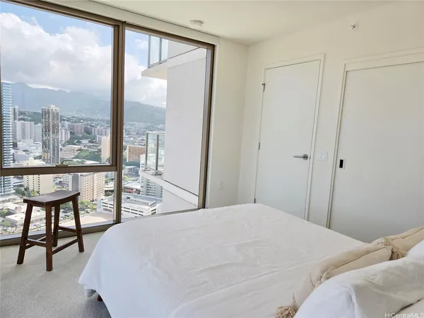 a bedroom with a large window and a bed