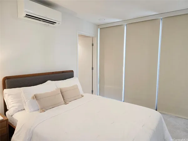 a bedroom with a bed and a shower