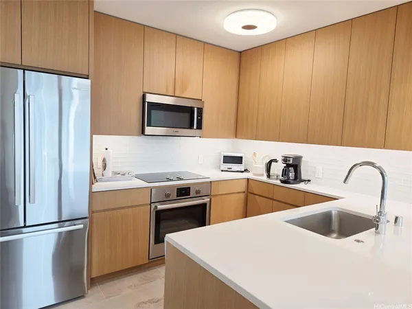 a kitchen with appliances a sink and a microwave