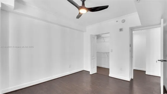 a view of an empty room with a ceiling fan