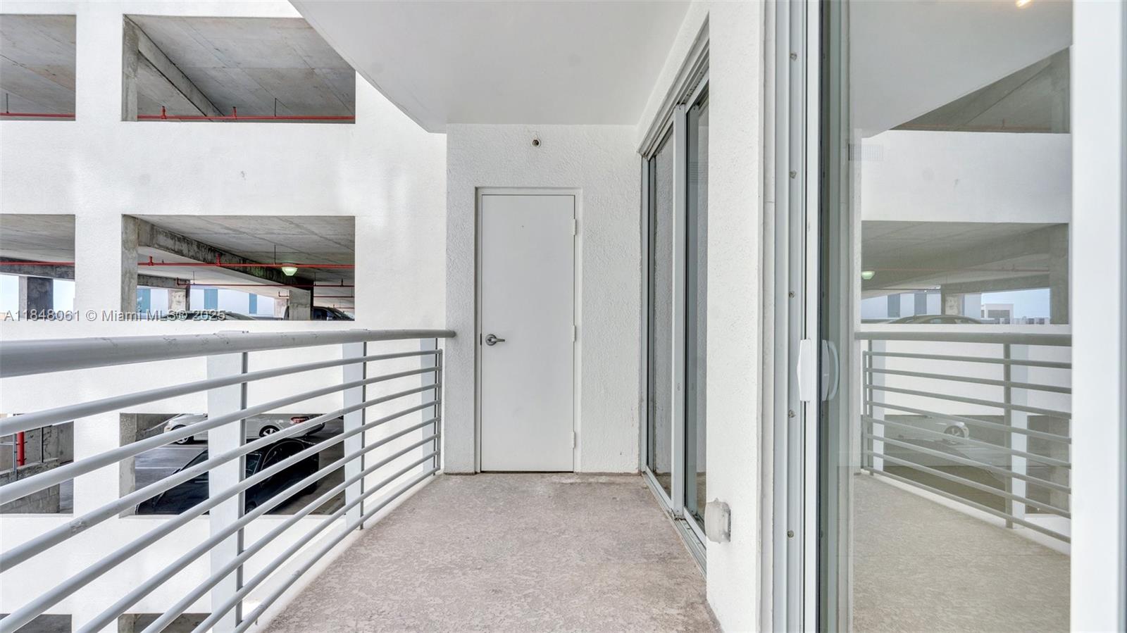 1830 Radius Drive, Unit 405 Hollywood, FL 33020 - Photo 17 of 19 a view of a hallway with workspace