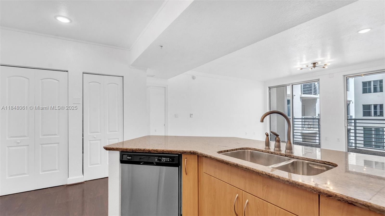1830 Radius Drive, Unit 405 Hollywood, FL 33020 - Photo 3 of 19 a kitchen with granite countertop a sink and cabinets