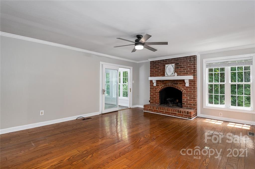 3243 Weidner Road Newton, NC 28658 - Photo 3 of 4 a view of a livingroom with a fireplace a ceiling fan and a window