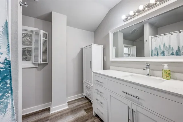 a bathroom with a double vanity sink and a mirror