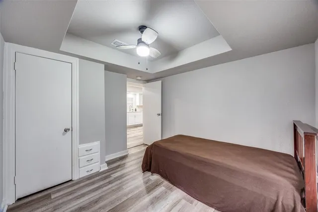 a bedroom with a large bed and a chandelier