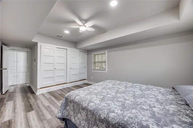 a bedroom with a large bed and a chandelier