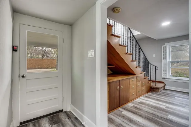 a view of entryway and hall with wooden floor