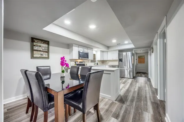 a view of a dining room with furniture and wooden floor