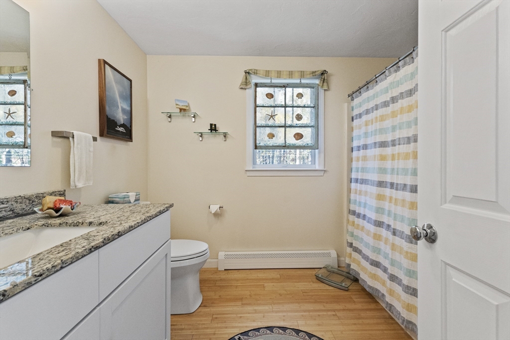 100 Orchard Drive Eastham, MA 02642 - Photo 14 of 31 a bathroom with a granite countertop sink toilet and shower