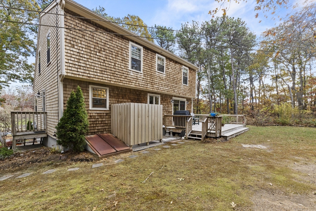 100 Orchard Drive Eastham, MA 02642 - Photo 26 of 31 a view of a house with a yard and wooden fence