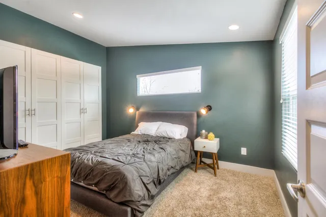 a bedroom with a bed and a lamp