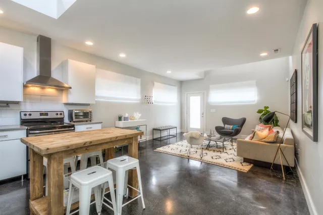 a kitchen with a stove a table and chairs in it