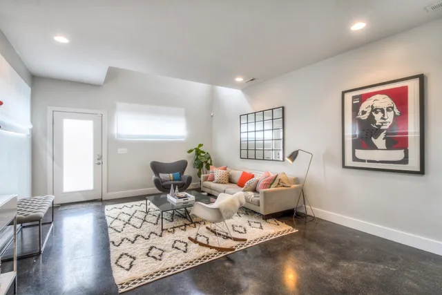 a living room with furniture a rug and a window