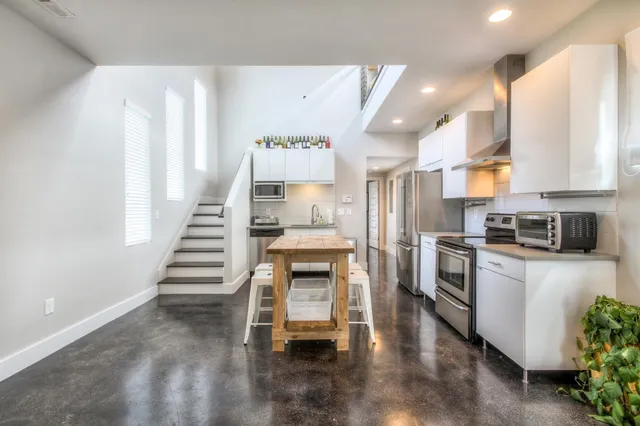 a kitchen with refrigerator and stove