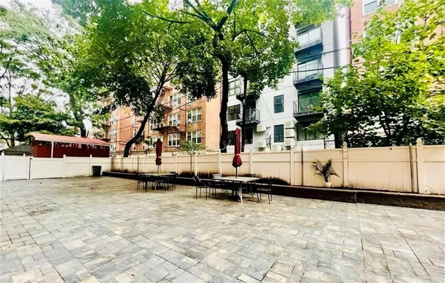 a view of a large white house with a yard in front of it