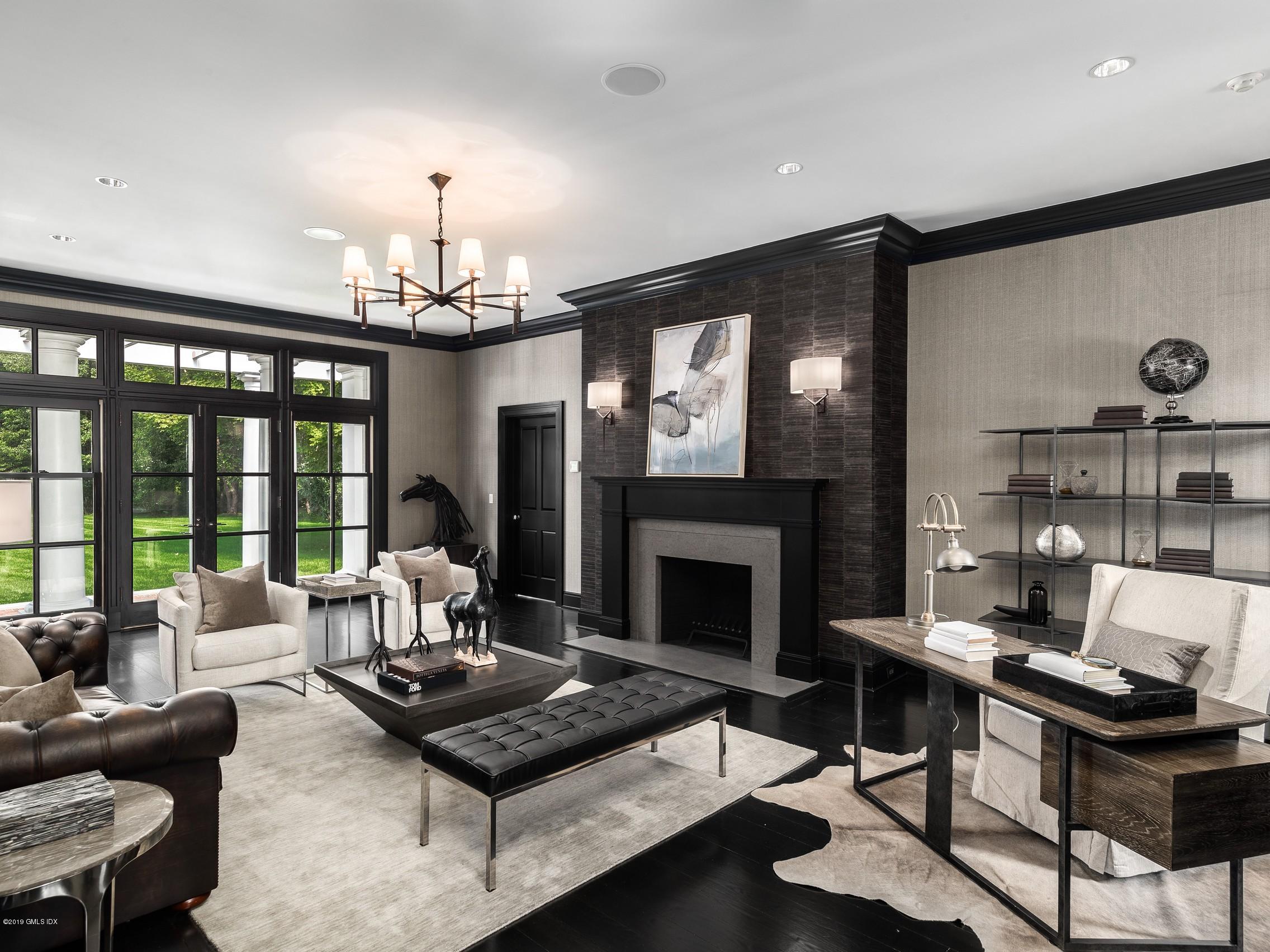 16 Andrews Farm Road Greenwich, CT 06831 - Photo 14 of 44 a living room with furniture a chandelier and a fireplace
