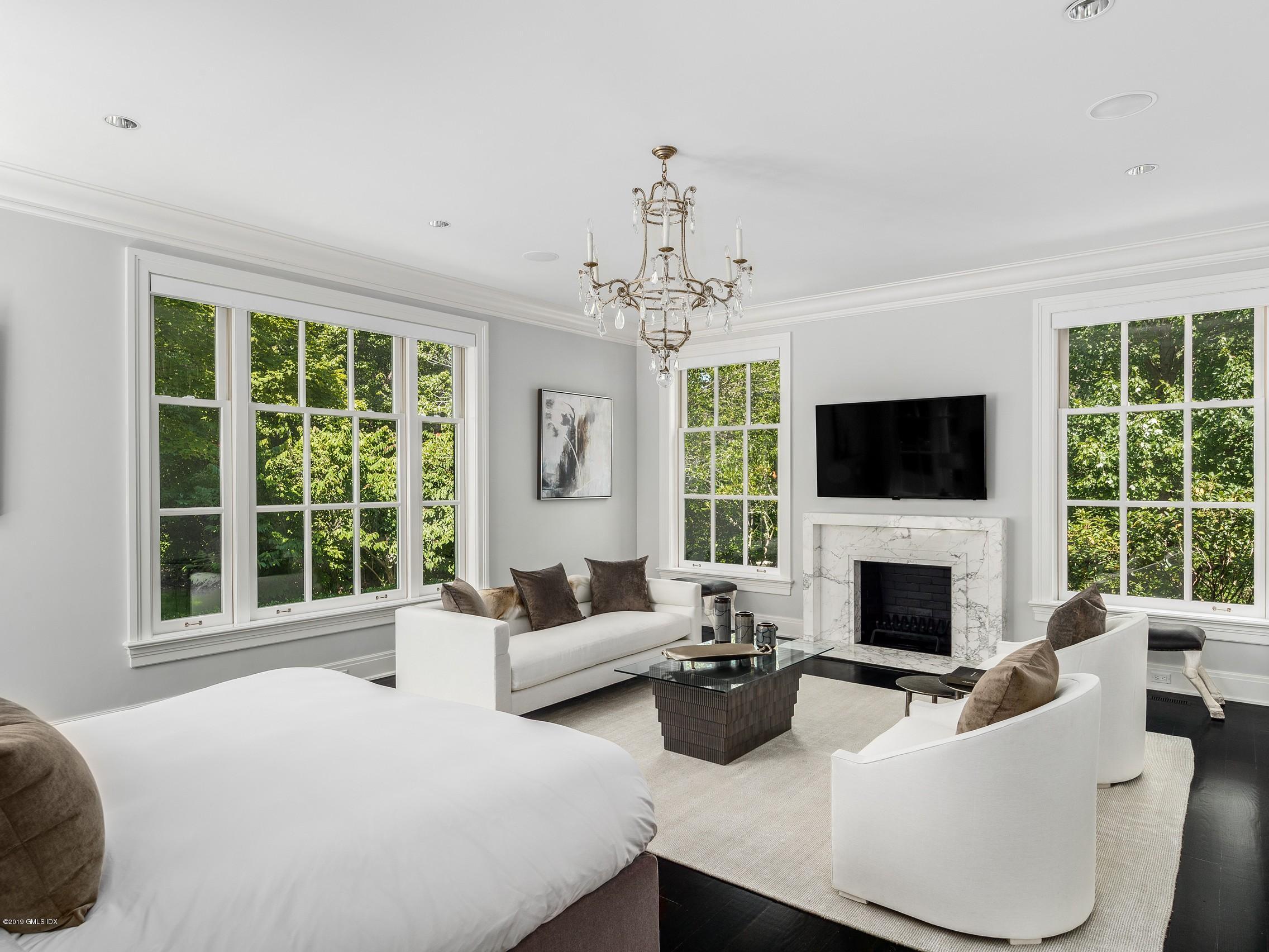 16 Andrews Farm Road Greenwich, CT 06831 - Photo 17 of 44 a living room with furniture fireplace and a large window