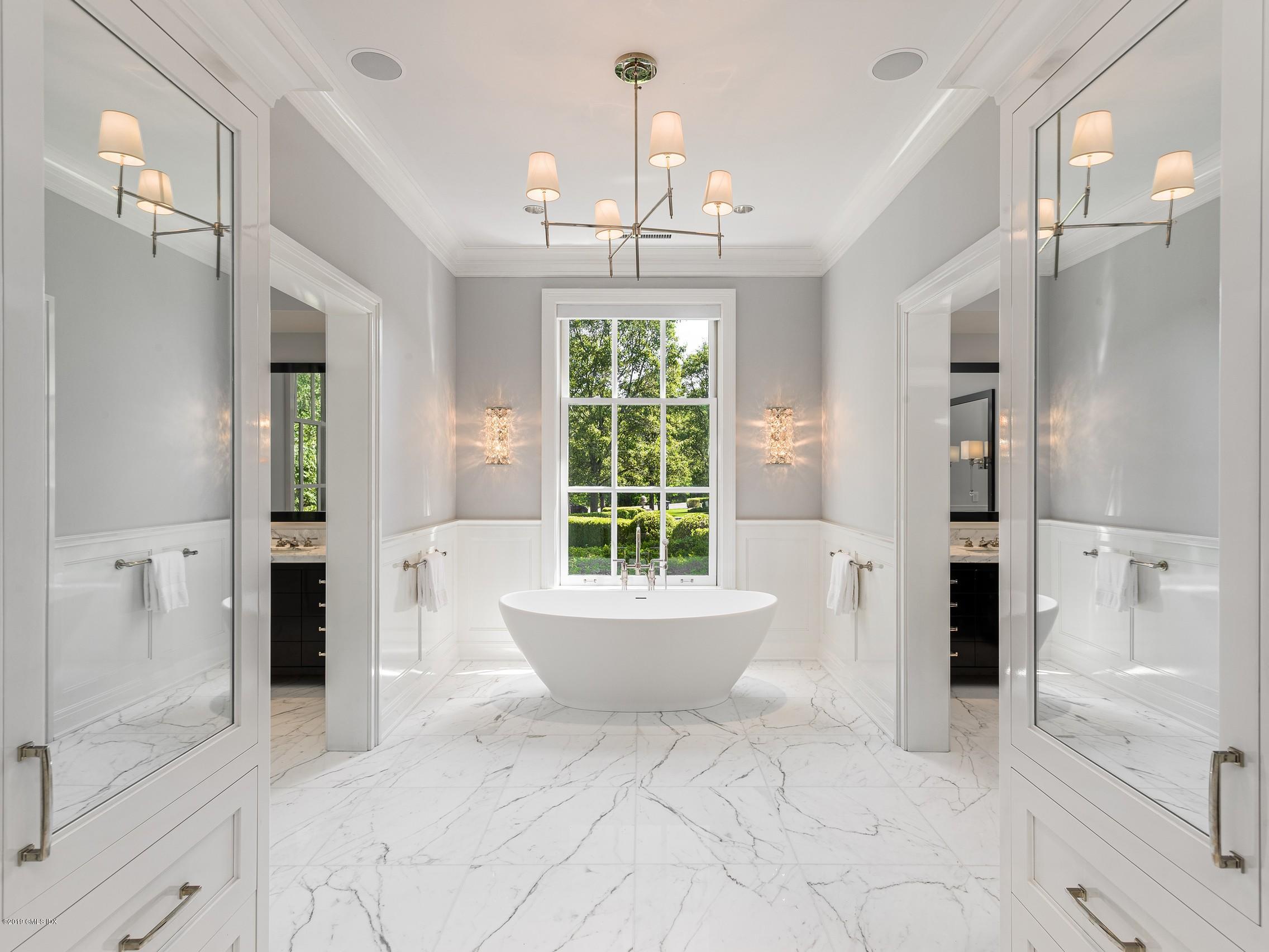 16 Andrews Farm Road Greenwich, CT 06831 - Photo 19 of 44 a bathroom with a bathtub shower sink and mirror