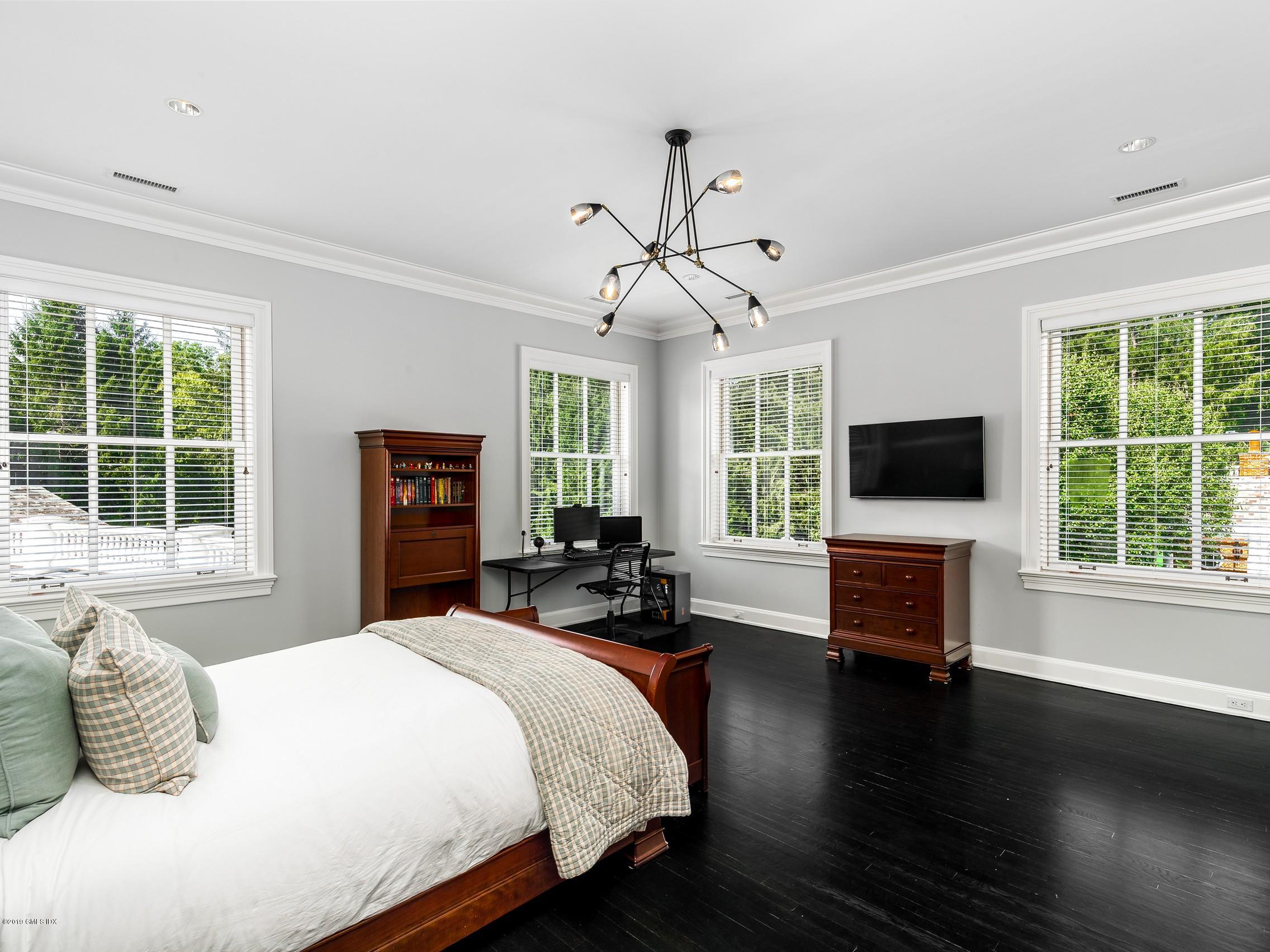 16 Andrews Farm Road Greenwich, CT 06831 - Photo 22 of 44 a bedroom with a bed and a flat screen tv